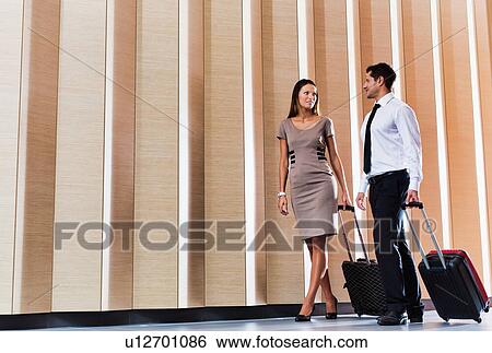 Businessman and businesswoman attending business conference in a hotel View Large Photo Image Stock Photograph - Businessman and businesswoman attending business conference in a hotel. Fotosearch