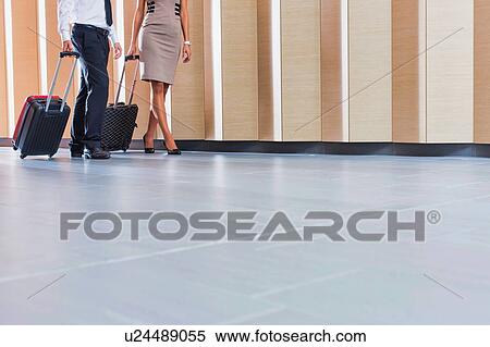Stock Photography - Businessman and businesswoman attending business conference in a hotel. Fotosearch