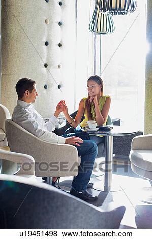 Businessman and businesswoman dating in coffee shop View Large Photo Image Stock Photo - Businessman and businesswoman dating in coffee shop. Fotosearch