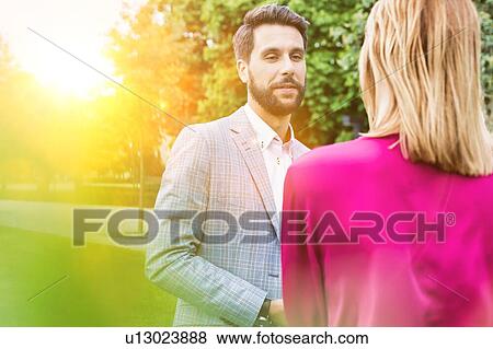 Businessman discussing plans with businesswoman on meeting outdoor View Large Photo Image Stock Photo - Businessman discussing plans with businesswoman on meeting outdoor. Fotosearch