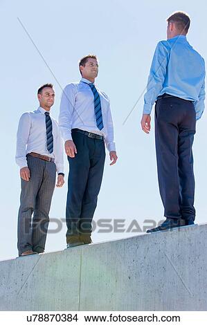 Businessman standing in office rooftop View Large Photo Image Picture - Businessman standing in office rooftop. Fotosearch