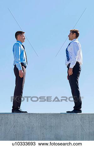 Businessman standing in office rooftop View Large Photo Image Stock Image - Businessman standing in office rooftop. Fotosearch