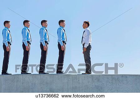 Stock Image - Businessman standing in office rooftop. Fotosearch