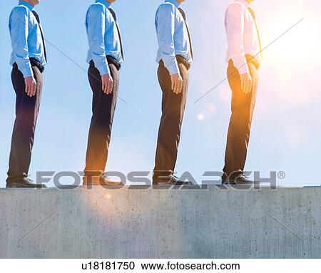 Stock Image - Businessman standing in office rooftop. Fotosearch