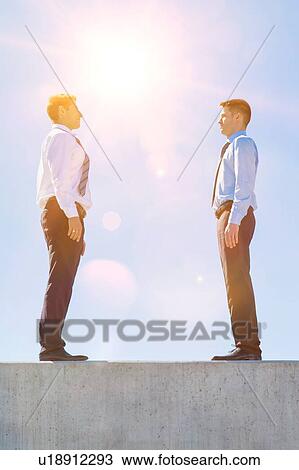 Stock Image - Businessman standing in office rooftop. Fotosearch