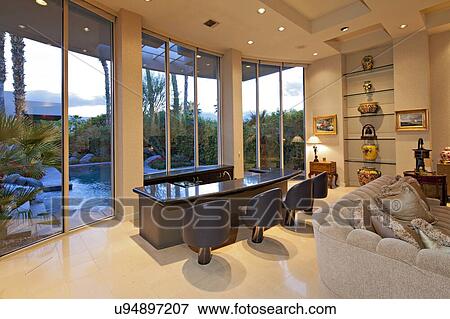 Chairs along counter near window in living room of mansion View Large Photo Image Stock Photo - Chairs along counter near window in living room of mansion. Fotosearch