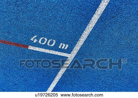 Stock Photography - Close up of 400 meter sprint blue tracking field. Fotosearch