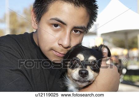 Close-up of a teenage boy with pet dog View Large Photo Image Stock Photography - Close-up of a teenage boy with pet dog. Fotosearch