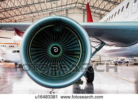 Stock Image - Close up of airplane engine in airport. Fotosearch