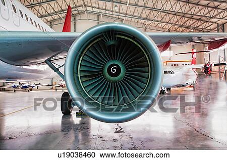 Stock Image - Close up of airplane engine in airport. Fotosearch