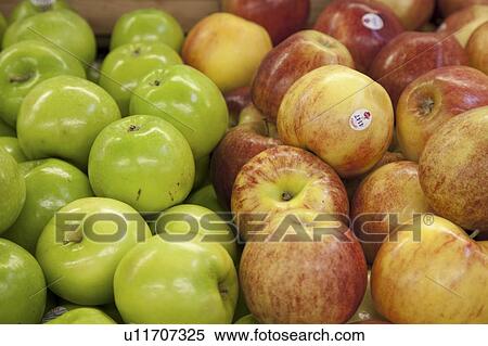 Stock Photography - Close-up of apples on display in market. Fotosearch