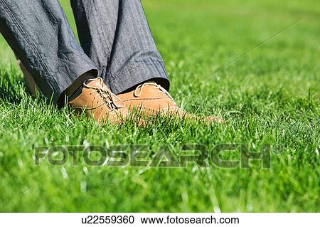 Close up of businessman foot on the grass View Large Photo Image Stock Image - Close up of businessman foot on the grass . Fotosearch