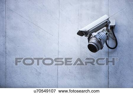 Stock Photo - Close-up of CCTV security camera on wall. Fotosearch