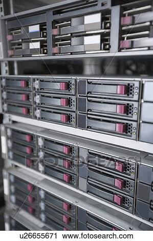 Stock Image - Close-up of computer network hardware in server room. Fotosearch