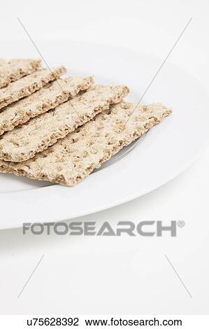 Stock Image - Close-up of crackers in plate. Fotosearch