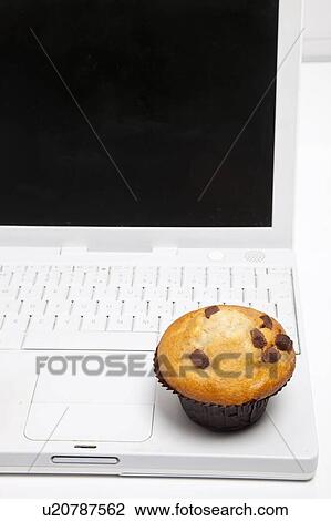 Close-up of cupcake and laptop View Large Photo Image Stock Image - Close-up of cupcake and laptop. Fotosearch