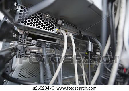 Stock Photograph - Close-up of data cable plugs connected to servers. Fotosearch