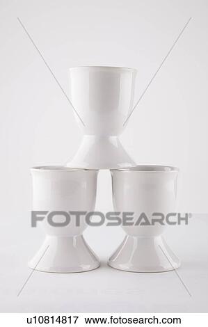 Stock Photo - Close-up of empty egg cups arranged against white background. Fotosearch