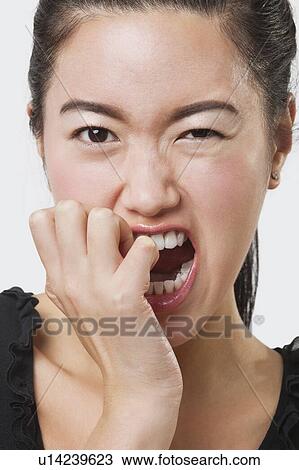 Close-up of frustrated Chinese woman over white background View Large Photo Image Stock Image - Close-up of frustrated Chinese woman over white background. Fotosearch
