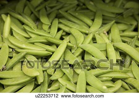 Stock Image - Close-up of green peas in farmer's market. Fotosearch