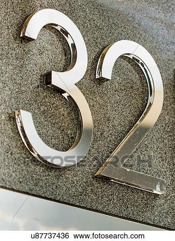 Stock Photograph - Close up of house number 32. Fotosearch