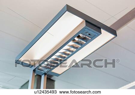 Stock Image - Close up of lamp shade in office. Fotosearch