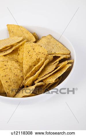 Stock Photo - Close-up of nachos in bowl over white background. Fotosearch