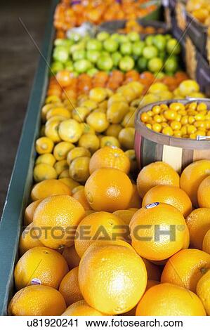Stock Image - Close-up of oranges on display in market. Fotosearch