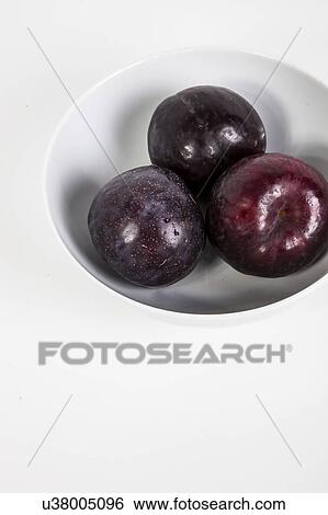 Close-up of plums in bowl View Large Photo Image Stock Photograph - Close-up of plums in bowl. Fotosearch