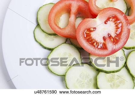 Close-up of sliced tomatoes and cucumbers in plate View Large Photo Image Stock Image - Close-up of sliced tomatoes and cucumbers in plate. Fotosearch