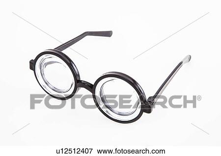 Stock Photo - Close-up of thick glasses over white background. Fotosearch