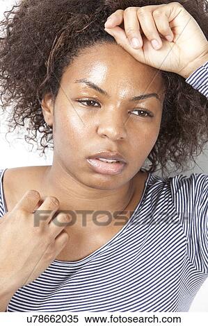 Close-up of tired young woman looking away View Large Photo Image Stock Photography - Close-up of tired young woman looking away. Fotosearch