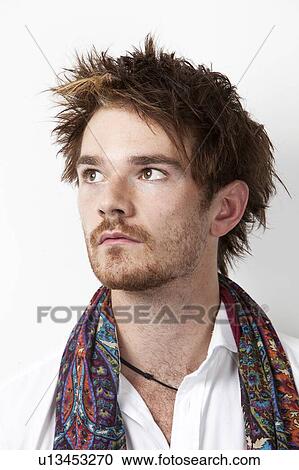Stock Image - Close-up of young man thinking against white background. Fotosearch