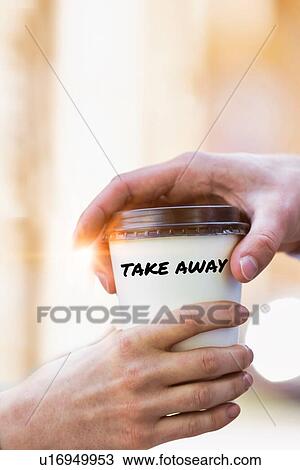 Stock Image - Close up photo of businesswoman giving businessman a cup of coffee latte. Fotosearch