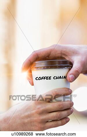 Stock Photo - Close up photo of businesswoman giving businessman a cup of coffee . Fotosearch