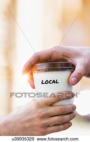 Stock Photo - Close up photo of businesswoman giving businessman a cup of local coffee . Fotosearch