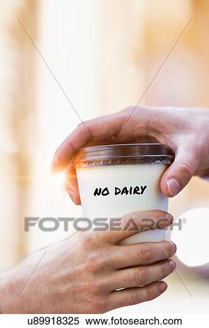Stock Photography - Close up photo of businesswoman giving businessman a cup of coffee with no dairy. Fotosearch