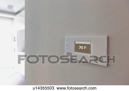 Stock Image - Close up photo of modern temperature touch switch board on wall. Fotosearch