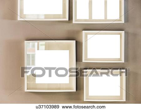 Stock Photo - Close up photo of picture frames on the wall in new apartment. Fotosearch