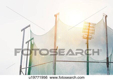 Stock Photograph - Close up photo of stadium lights against sky. Fotosearch