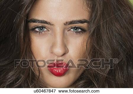 Stock Photo - Close-up portrait of a seductive young female puckering lips. Fotosearch