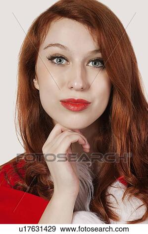 Stock Photo - Close-up portrait of beautiful woman against gray background. Fotosearch