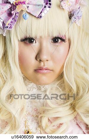Close-up portrait of cute woman in doll costume over purple background View Large Photo Image Stock Photo - Close-up portrait of cute woman in doll costume over purple background. Fotosearch