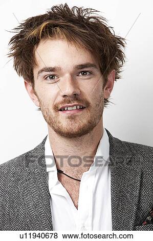 Stock Photo - Close-up portrait of handsome young man against white background. Fotosearch