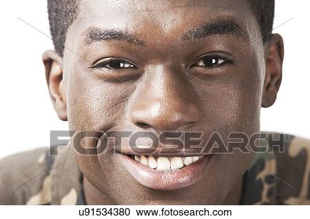 Close-up portrait of happy young man against white background View Large Photo Image Stock Image - Close-up portrait of happy young man against white background. Fotosearch