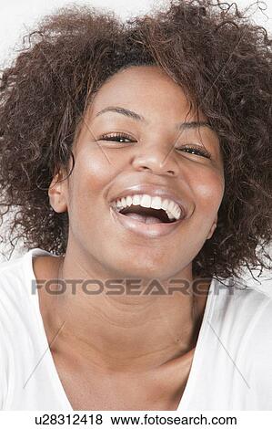 Close-up portrait of joyful African American young woman laughing View Large Photo Image Stock Photo - Close-up portrait of joyful African American young woman laughing. Fotosearch