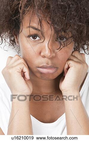 Stock Photo - Close-up portrait of sad African American young woman. Fotosearch