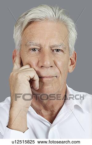 Close-up portrait of senior man thinking over gray background View Large Photo Image Stock Photography - Close-up portrait of senior man thinking over gray background. Fotosearch