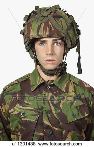 Stock Photo - Close-up portrait of soldier against gray background. Fotosearch