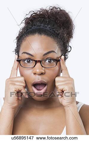 Close-up portrait of surprised African American young woman with mouth open over white background View Large Photo Image Stock Photo - Close-up portrait of surprised African American young woman with mouth open over white background. Fotosearch